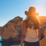 young-woman-looking-caves-ponta-da-piedade-algarve